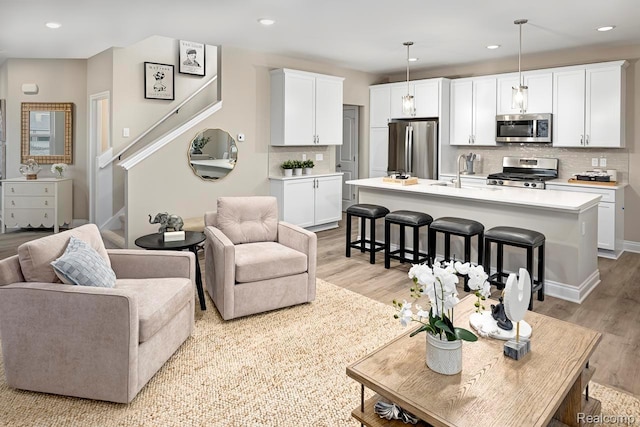 809 Cortland Ln, Troy, MI 48085 - living area featuring light wood-type flooring, stairs, and recessed lighting