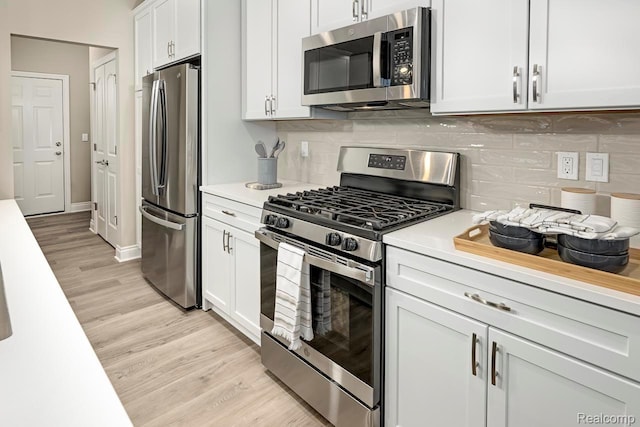809 Cortland Ln, Troy, MI 48085 - kitchen with appliances with stainless steel finishes, light countertops, light wood-style floors, and decorative backsplash