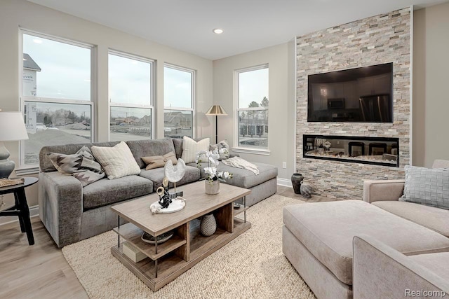 809 Cortland Ln, Troy, MI 48085 - living room featuring wood finished floors, a stone fireplace, and recessed lighting
