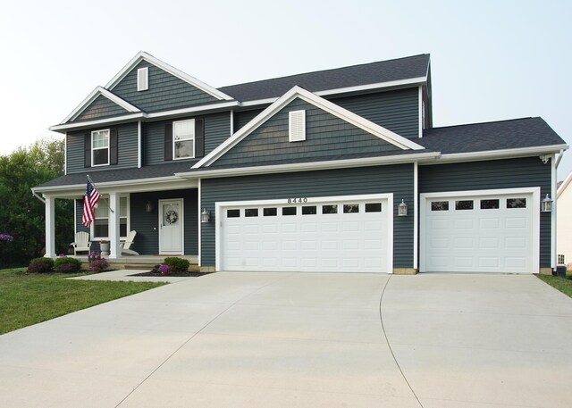 8440 Irish Mist, Onsted, MI 49265 - view of front of property with an attached garage, a porch, and driveway