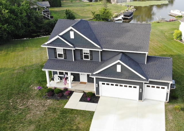 8440 Irish Mist, Onsted, MI 49265 - craftsman-style home featuring roof with shingles, a water view, an attached garage, driveway, and a front lawn
