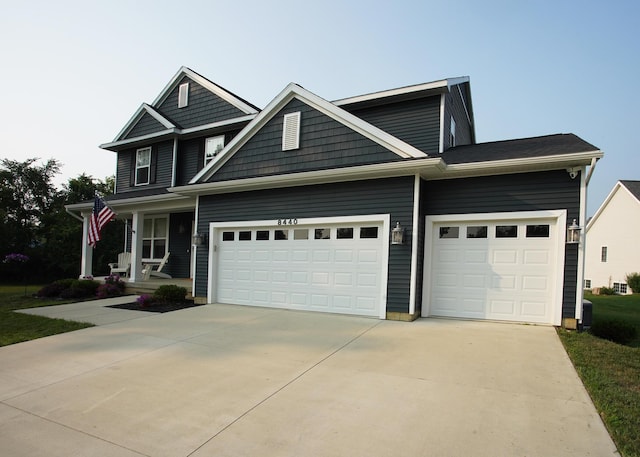 8440 Irish Mist, Onsted, MI 49265 - craftsman-style house featuring concrete driveway, a garage, and a porch