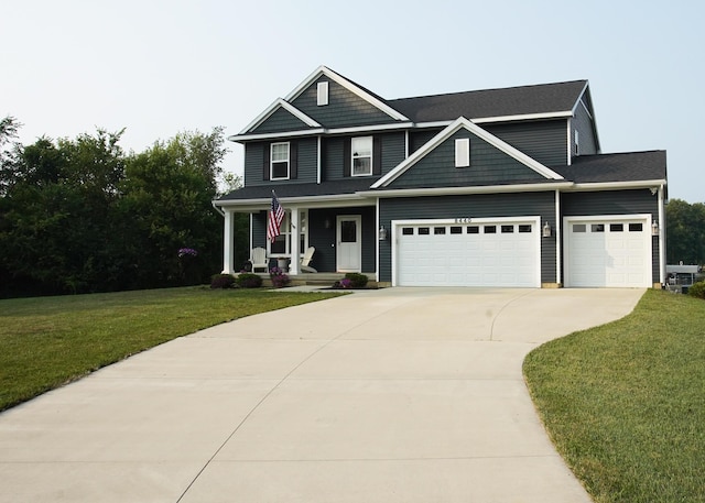 8440 Irish Mist, Onsted, MI 49265 - view of front of house with covered porch, concrete driveway, a front yard, and a garage