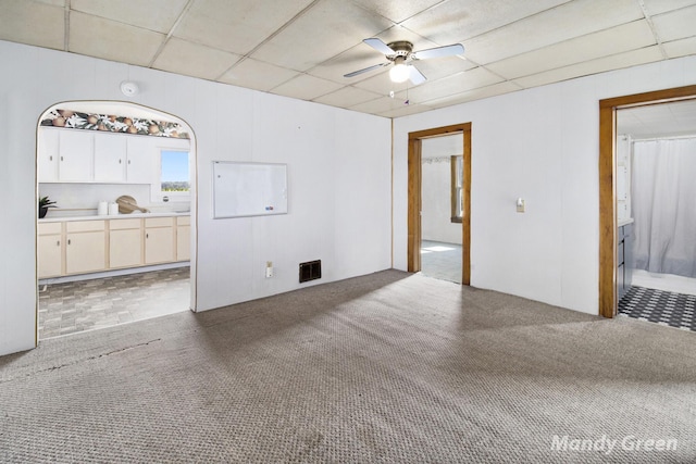 4651 E Pierce Rd, Ithaca, MI 48847 - unfurnished living room featuring carpet flooring, a ceiling fan, and a paneled ceiling