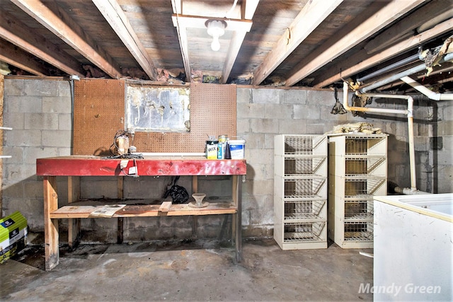 4651 E Pierce Rd, Ithaca, MI 48847 - unfinished basement with a workshop area and refrigerator