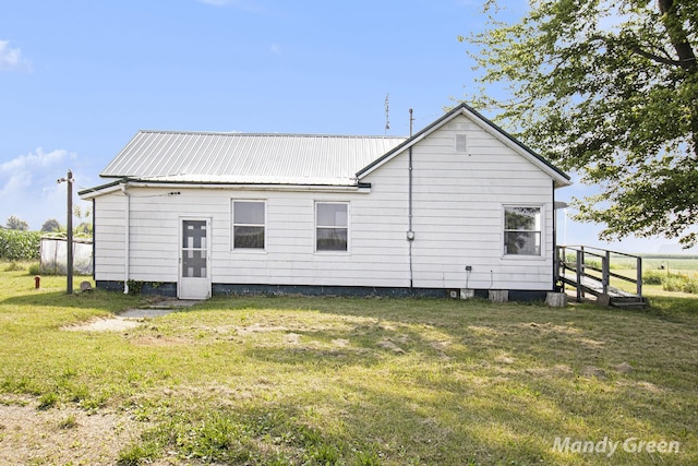 4651 E Pierce Rd, Ithaca, MI 48847 - back of property with a lawn and a metal roof