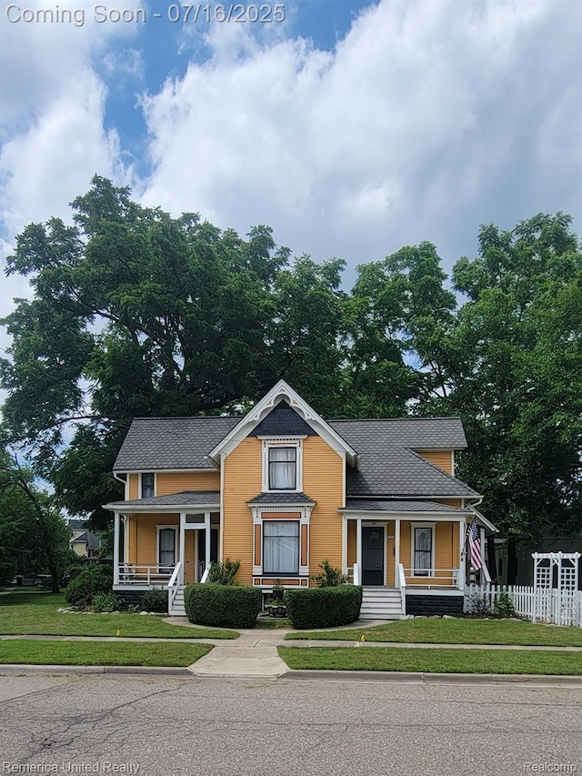 122 S Chestnut St, Howell, MI 48843 - victorian home featuring covered porch and roof with shingles