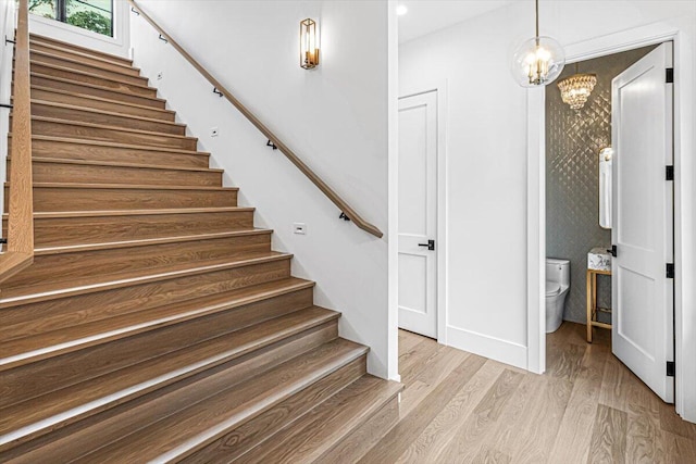 7462 Youngren Rd, Three Oaks, MI 49128 - stairs featuring a chandelier, wood finished floors, and recessed lighting