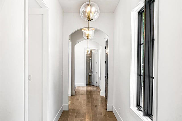 7462 Youngren Rd, Three Oaks, MI 49128 - hallway with arched walkways and wood finished floors