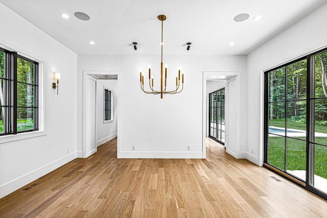 7462 Youngren Rd, Three Oaks, MI 49128 - empty room with a chandelier, light wood-style flooring, and recessed lighting