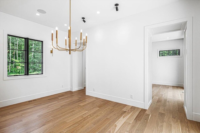 7462 Youngren Rd, Three Oaks, MI 49128 - unfurnished room featuring light wood-style floors, a chandelier, and recessed lighting