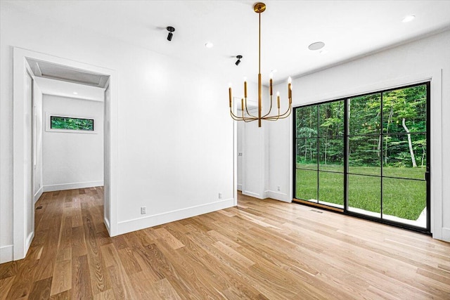 7462 Youngren Rd, Three Oaks, MI 49128 - unfurnished dining area with light wood-style floors and a chandelier