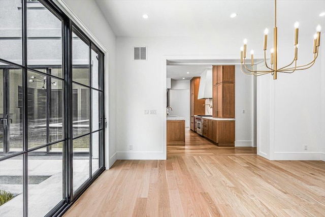 7462 Youngren Rd, Three Oaks, MI 49128 - spare room with light wood-style floors, a chandelier, healthy amount of natural light, and recessed lighting