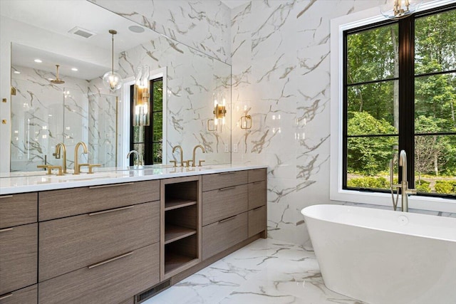 7462 Youngren Rd, Three Oaks, MI 49128 - full bathroom featuring double vanity, a marble finish shower, a soaking tub, marble tiled flooring, and stone wall