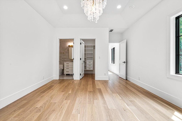 7462 Youngren Rd, Three Oaks, MI 49128 - unfurnished bedroom featuring a chandelier, light wood finished floors, a spacious closet, connected bathroom, and recessed lighting