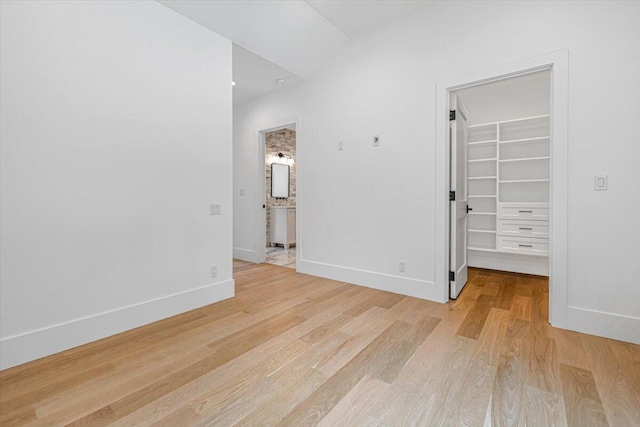7462 Youngren Rd, Three Oaks, MI 49128 - unfurnished bedroom featuring light wood finished floors and a spacious closet