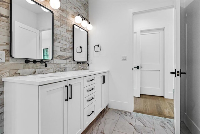 7462 Youngren Rd, Three Oaks, MI 49128 - bathroom featuring double vanity and marble look tiles