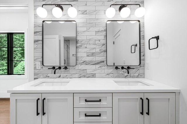 7462 Youngren Rd, Three Oaks, MI 49128 - full bathroom featuring double vanity, tasteful backsplash, and wood finished floors