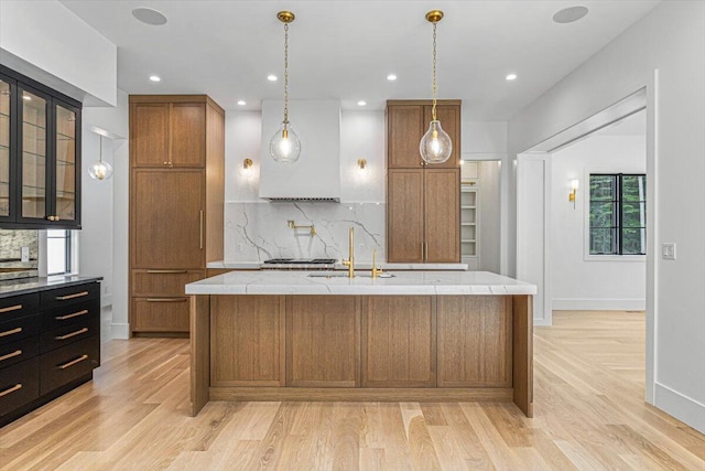 7462 Youngren Rd, Three Oaks, MI 49128 - kitchen featuring light wood-style floors, backsplash, brown cabinets, and recessed lighting