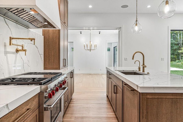 7462 Youngren Rd, Three Oaks, MI 49128 - kitchen with stainless steel range, custom range hood, light wood-type flooring, a chandelier, and hanging light fixtures