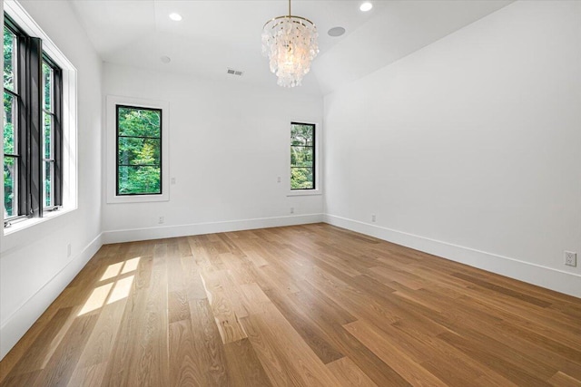 7462 Youngren Rd, Three Oaks, MI 49128 - spare room with plenty of natural light, a chandelier, light wood-type flooring, vaulted ceiling, and recessed lighting