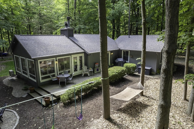 1227 Beech Dr, South Haven, MI 49090 - back of house featuring roof with shingles, a wooden deck, french doors, and a chimney