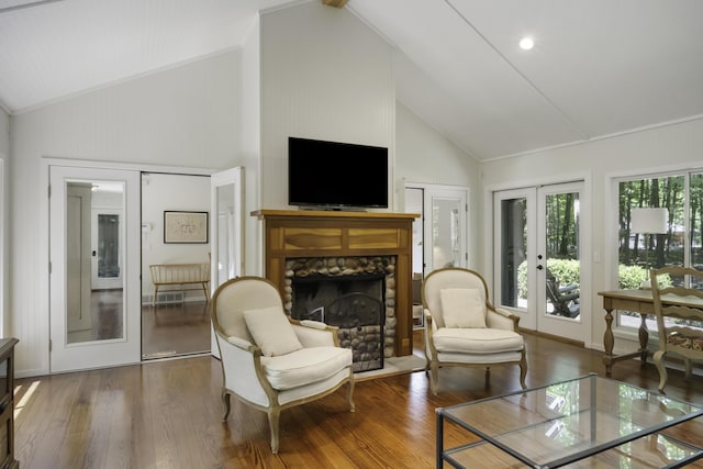 1227 Beech Dr, South Haven, MI 49090 - living area featuring french doors, high vaulted ceiling, a stone fireplace, and wood finished floors