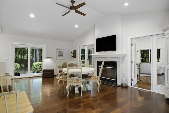 1227 Beech Dr, South Haven, MI 49090 - dining area with ceiling fan, wood finished floors, a glass covered fireplace, high vaulted ceiling, and recessed lighting