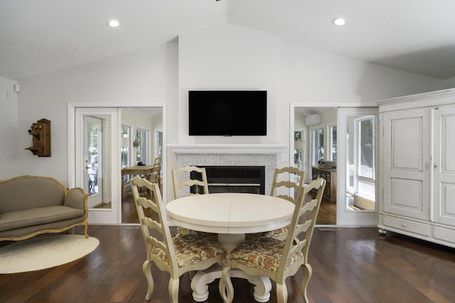 1227 Beech Dr, South Haven, MI 49090 - dining space with vaulted ceiling, dark wood-style flooring, a fireplace, recessed lighting, and a wall mounted AC