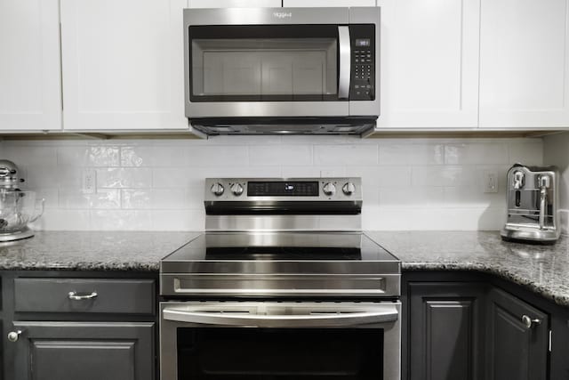 1227 Beech Dr, South Haven, MI 49090 - kitchen with stainless steel appliances, white cabinetry, tasteful backsplash, and light stone counters