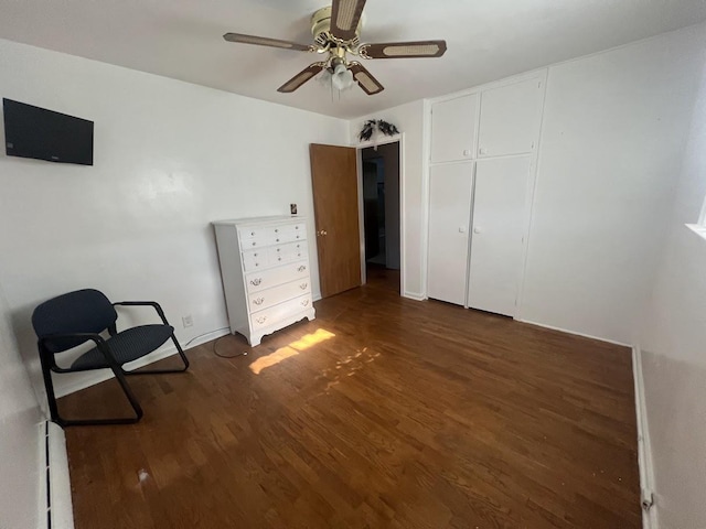 4518 Huckleberry Ln, Flint, MI 48507 - unfurnished bedroom featuring dark wood-style floors, ceiling fan, a closet, and baseboard heating