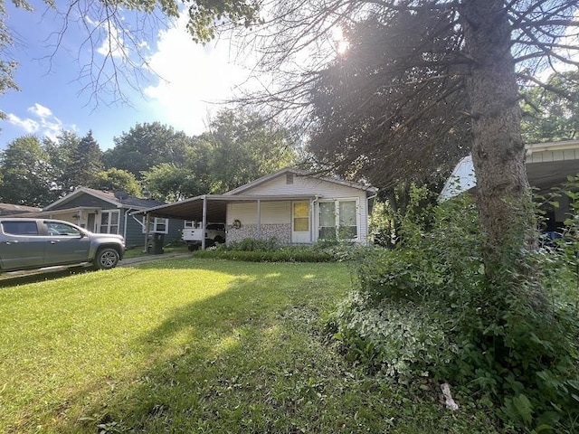 4518 Huckleberry Ln, Flint, MI 48507 - view of front of house featuring a front lawn and an attached carport