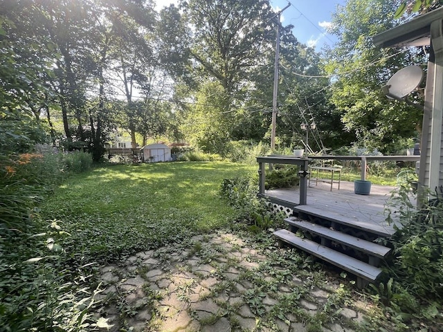 4518 Huckleberry Ln, Flint, MI 48507 - view of grassy yard featuring a wooden deck and a storage shed
