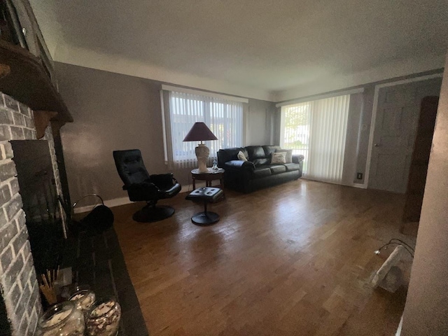 4518 Huckleberry Ln, Flint, MI 48507 - living room featuring a stone fireplace and wood finished floors