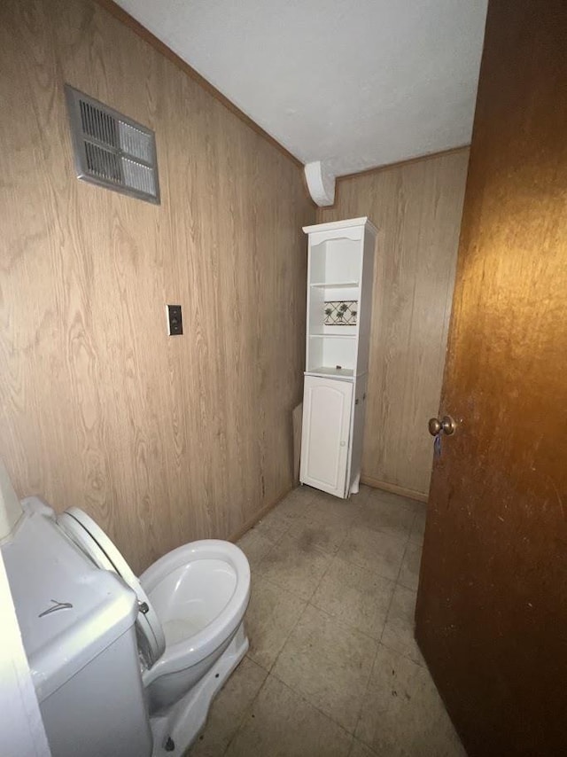 4518 Huckleberry Ln, Flint, MI 48507 - bathroom featuring wood walls and toilet