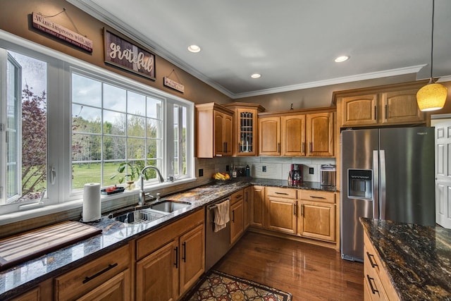 3725 S Creek Ln, Dryden, MI 48428 - kitchen with brown cabinets, stainless steel appliances, ornamental molding, glass insert cabinets, and dark wood finished floors