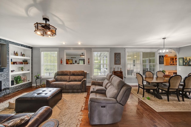 3725 S Creek Ln, Dryden, MI 48428 - living area featuring crown molding, healthy amount of natural light, wood finished floors, and built in shelves