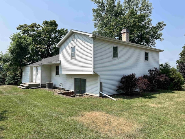 1569 N Rollin Hwy, Hudson, MI 49247 - back of house featuring a lawn and a chimney