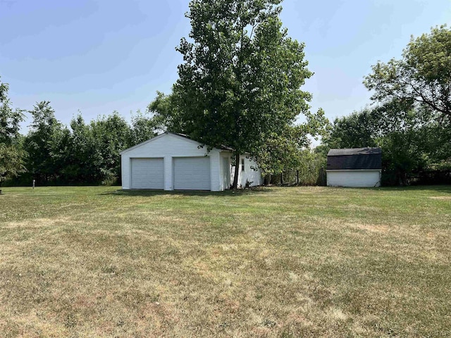 1569 N Rollin Hwy, Hudson, MI 49247 - view of green lawn featuring an outbuilding and a garage