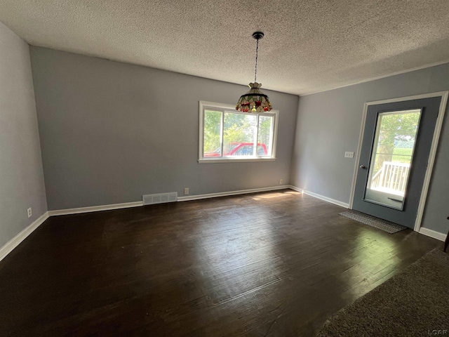 1569 N Rollin Hwy, Hudson, MI 49247 - empty room featuring healthy amount of natural light, dark wood-style floors, and a textured ceiling