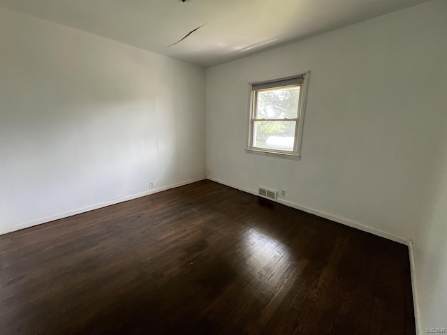 1569 N Rollin Hwy, Hudson, MI 49247 - spare room with dark wood-type flooring and baseboards