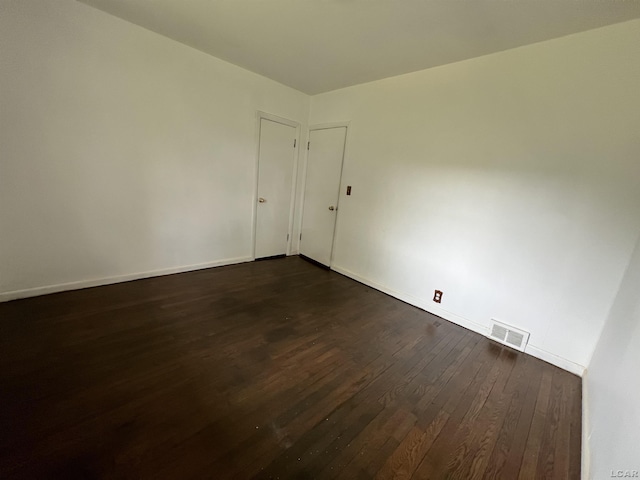 1569 N Rollin Hwy, Hudson, MI 49247 - empty room with dark wood-style flooring and baseboards
