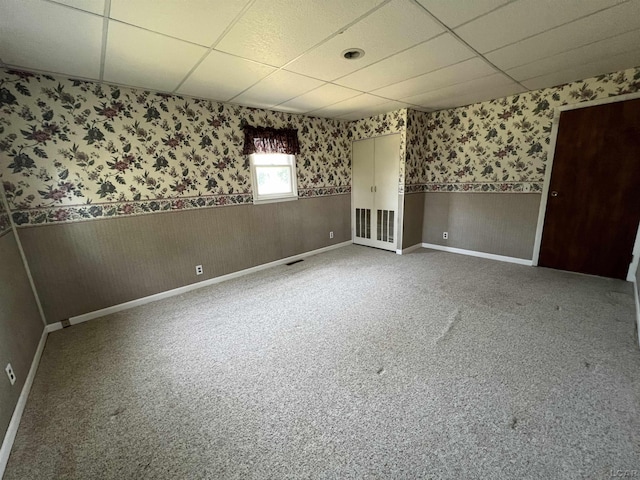 1569 N Rollin Hwy, Hudson, MI 49247 - empty room with a paneled ceiling, wallpapered walls, and wainscoting