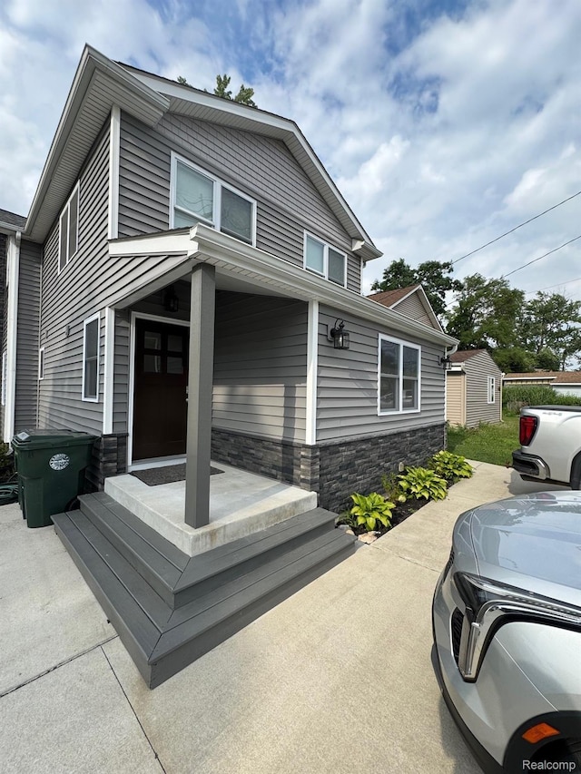 677 King Cir, Lake Orion, MI 48362 - view of home's exterior featuring stone siding