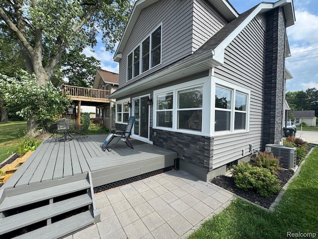 677 King Cir, Lake Orion, MI 48362 - back of property featuring a wooden deck and stone siding
