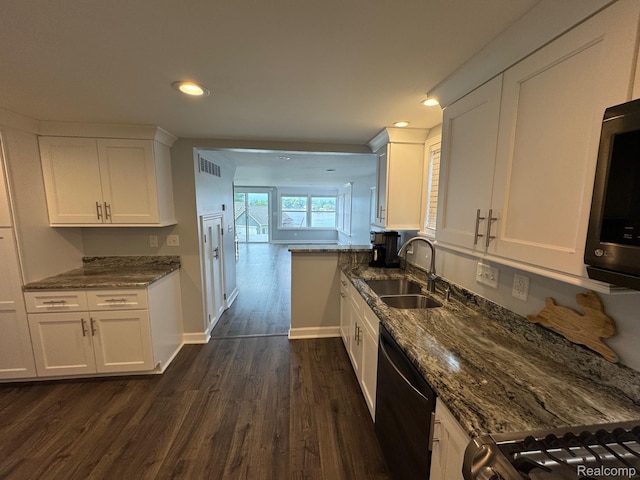 677 King Cir, Lake Orion, MI 48362 - kitchen featuring dark wood-type flooring, dark stone counters, white cabinetry, dishwashing machine, and recessed lighting