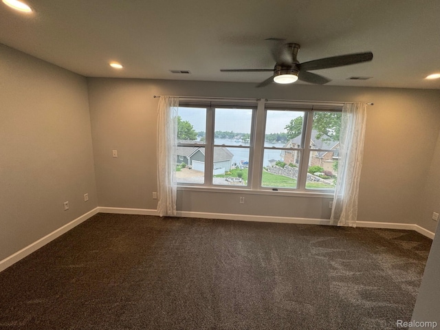 677 King Cir, Lake Orion, MI 48362 - spare room with healthy amount of natural light, ceiling fan, a water view, dark carpet, and recessed lighting