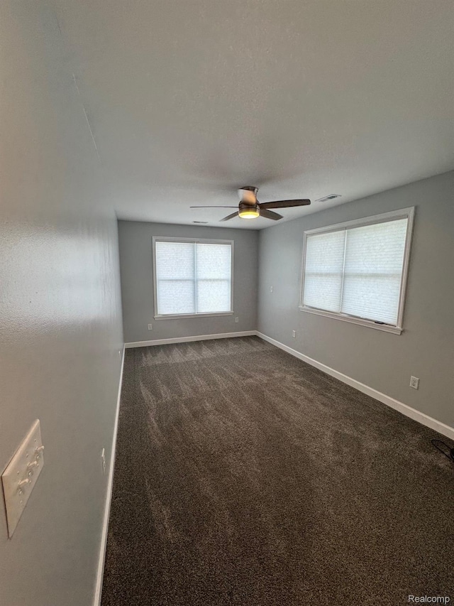 677 King Cir, Lake Orion, MI 48362 - empty room with a ceiling fan and dark carpet
