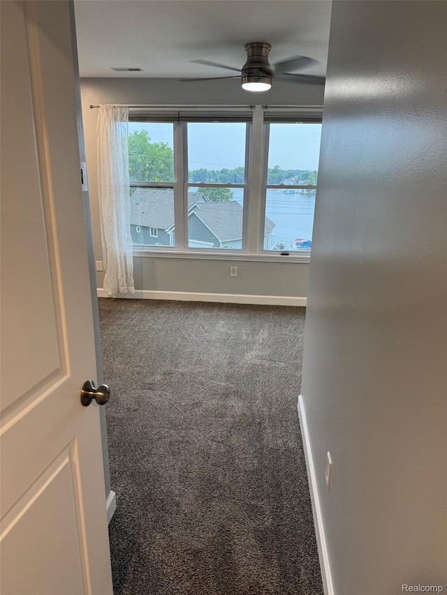 677 King Cir, Lake Orion, MI 48362 - unfurnished room featuring carpet floors, a ceiling fan, and a water view