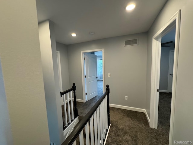 677 King Cir, Lake Orion, MI 48362 - hall featuring dark colored carpet, an upstairs landing, and recessed lighting